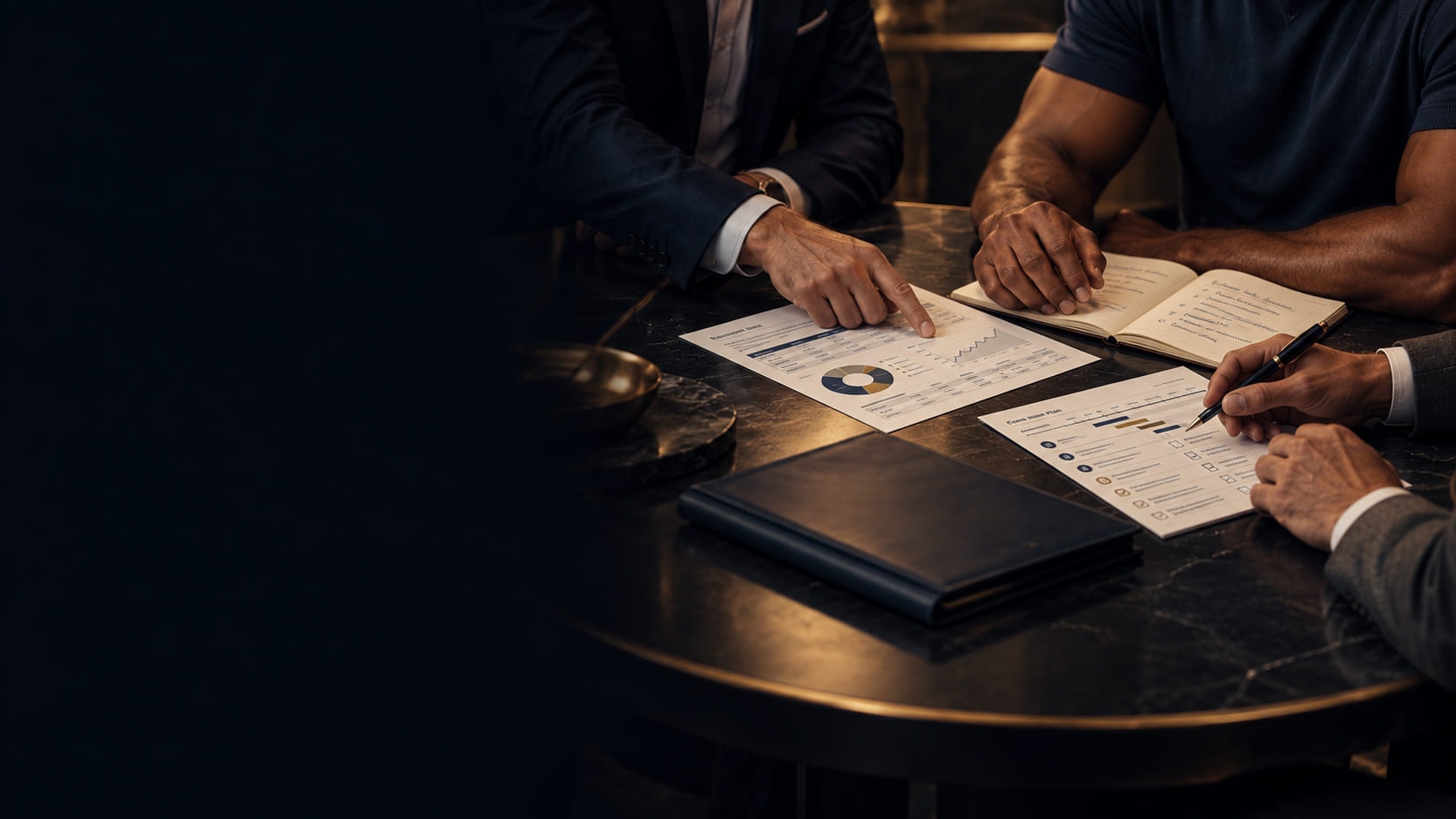 Advisers and an athlete reviewing plans across a table.